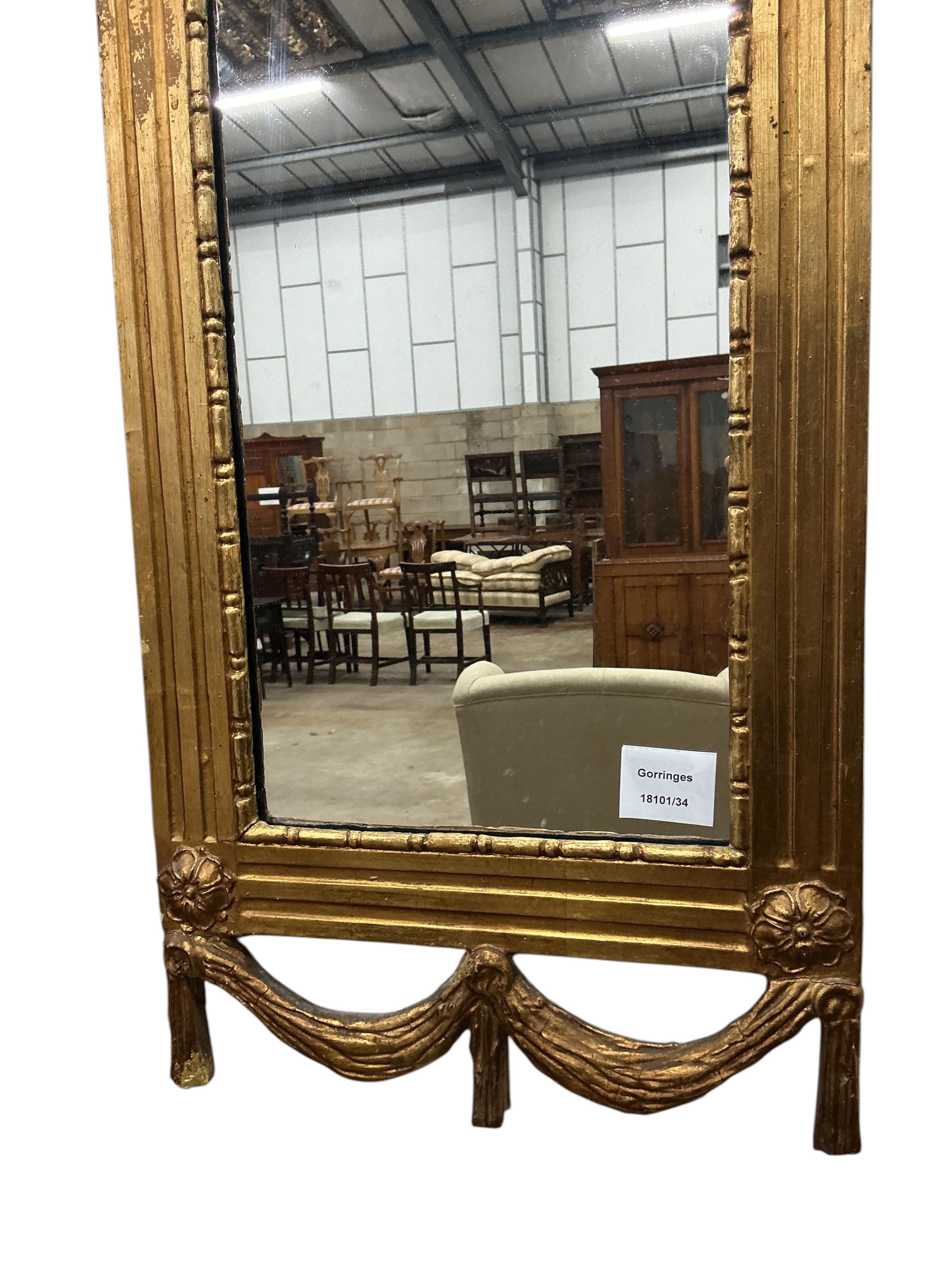 A small carved giltwood and composition wall mirror, width 33cm, height 110cm
